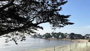 A coastal view with a sandy beach, a calm sea, and houses in the background. - VILLA BEAUMER - Beach Access . Sea view - TK60 (Carnac)