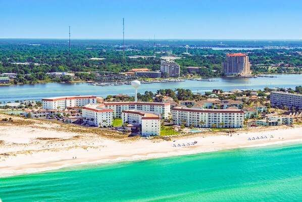 A coastal resort with beachfront villas, a marina, and a large hotel complex. - Modern 6th-floor condo with furnished balcony, ocean views, pools & beach access (Fort Walton Beach)