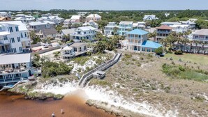 A coastal residential area with houses, a beach, and a boardwalk. - Tree-lined home with deck and AC - 1 block from the beach, Eastern Lake, and 30A (Santa Rosa Beach)