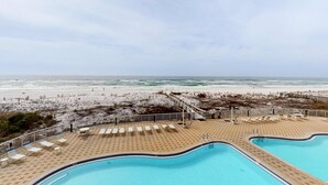 A pool area with two pools, a beach view, and a sandy walkway. - Sixth floor Summer Place condo w beach access, shared pool, and more (Fort Walton Beach)
