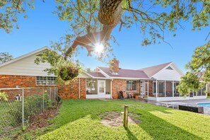 A house with a brick exterior, a covered patio, and a swimming pool. - Dog-Friendly Home with Private Pool & High-Speed WiFi - Near Beach & Boat Launch (Gulf Breeze)