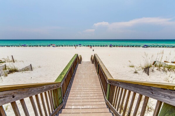 A wooden boardwalk leading to a sandy beach with a clear view of the ocean. - Gorgeous penthouse w shared outdoor pool, hot tub, tennis - Snowbird-friendly (Destin)
