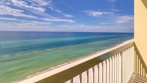 A balcony with a view of a beach and ocean. - Oceanfront condo w/ shared pools, hot tub, tennis courts - walk to the beach (Panama City Beach)