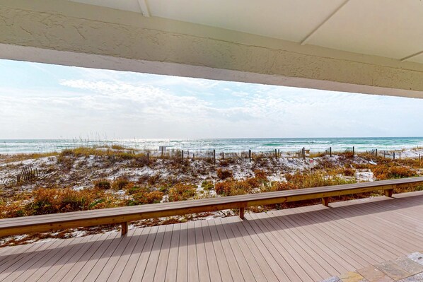 A wooden deck with a view of the beach and ocean. - 1st floor gulf front condo with amazing views, charcoal grills - walk to the beach (Santa Rosa Beach)