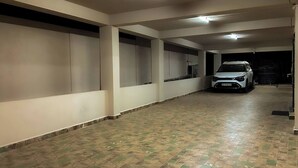 A multi-level parking garage with a white car parked in the lower level.