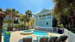 A pool area with lounge chairs and a circular pool. - Luxury home with private saltwater pool, spa, gazebo & deck - walk to beach (Santa Rosa Beach)