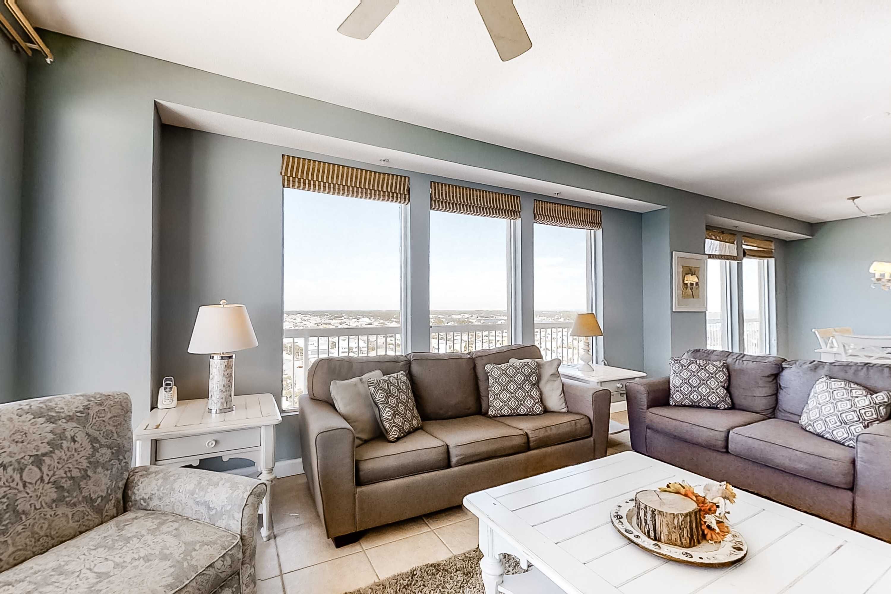 A living room with two sofas, a coffee table, and a side table with a lamp.