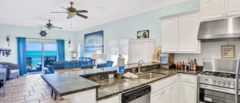 A modern kitchen with white cabinets, a stainless steel stove, and a dishwasher.