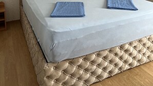A bed with a tufted headboard, two pillows, and two folded towels. - Apartment Lavaran 6 in Vir (Vir)