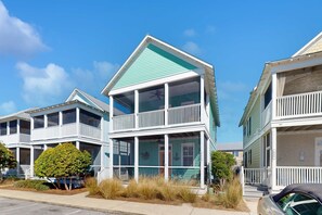 A coastal building with a green roof, white balconies, and a porch area. - 2-story beach cottage with pools, hot tub, gym, patio, & AC - dog-friendly (Port St. Joe)