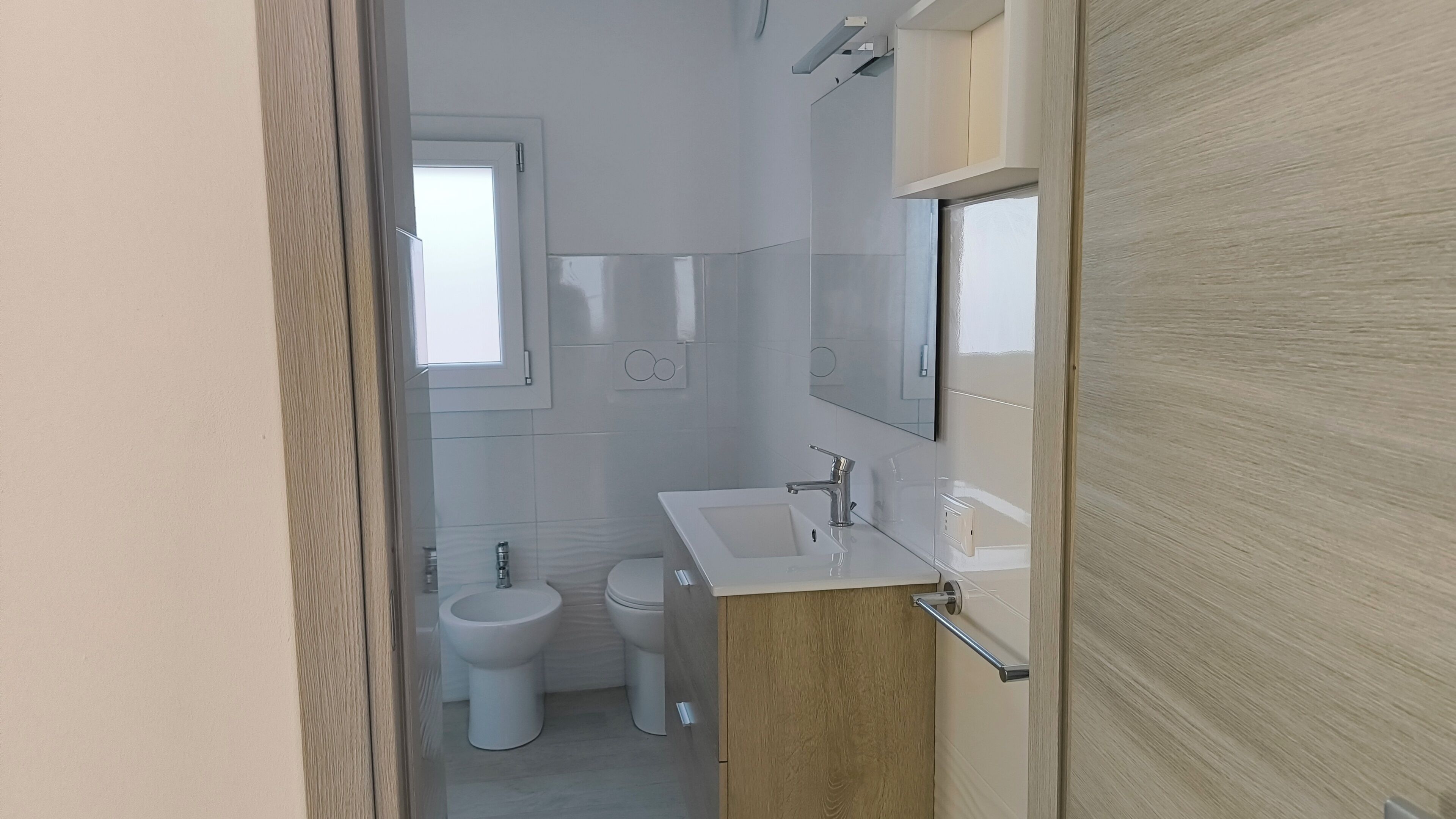 Un bany modern amb vàter, bidet i rentapel.