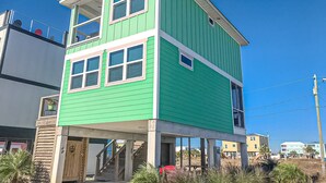 A two-story house with a green exterior and white trim. - Newly built, cottage with historical details, WiFi & central AC - steps to beach (Mexico Beach)