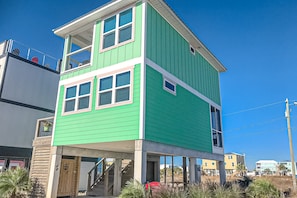 A two-story house with a green exterior and white trim. - Newly built, cottage with historical details, WiFi & central AC - steps to beach (Mexico Beach)