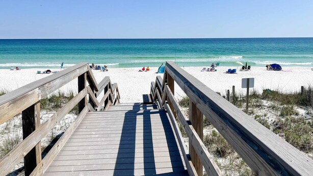 A wooden boardwalk leading to a sandy beach with clear blue water. - Pool-side condo with pool, private washer&dryer, walk to beach & free WiFi (Navarre Beach)