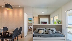 Un dormitorio moderno con cama, mesita de noche y un amplio ventanal.