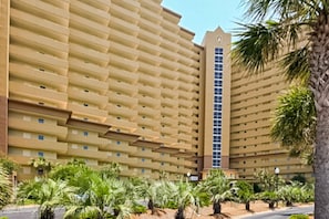 A large, multi-story hotel with a uniform facade and a central vertical tower. - Gulf-view condo at beachfront resort with pools, hot tub & 2 gyms (Destin)