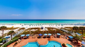 A resort pool area with a view of the beach and ocean. - Cozy condo with Gulf-front balcony & great views - near shops & dining (Destin)