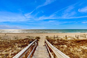 A wooden boardwalk leading to a beach with a clear sky. - Great, dog-friendly home with Gulf views, shared pool, just steps from the Gulf (St. George Island)