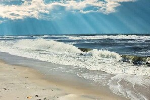 A beach with waves and a clear sky. - Beautiful home near the beach with community pool, gym, tennis (St. George Island)