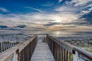 A wooden boardwalk leading to a beach with a clear sky and sun setting or rising. - Gulf-front townhome with gorgeous beach access, 4 Gulf-view decks, shared pools (Cape San Blas)