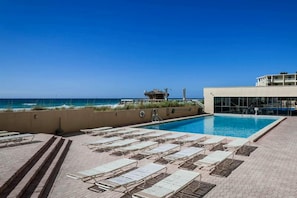 A pool area with lounge chairs and a view of the ocean. - 8th Floor Open Condo, On-site restaurant w bar, Multiple pools (Destin)
