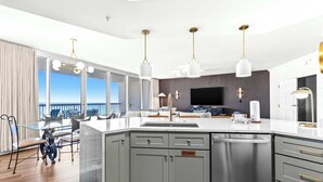 A modern kitchen with a large island, stainless steel appliances, and pendant lighting. - Experience the perfect blend of luxury, comfort, and breathtaking Gulf views at Silver Shells (Destin)