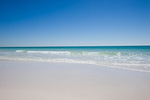 A beach with clear blue water and a sandy shore. - Islander 215 (Destin)