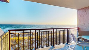 A balcony with a view of the ocean, featuring a railing and two chairs. - Spacious, 3rd-floor beachfront condo with stunning views, pool, pickleball, & AC (Fort Walton Beach)