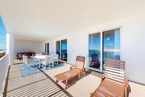Outdoor dining - Sixth-floor oceanfront condo with spacious balcony, WiFi, shared pool & hot tub (Panama City Beach)