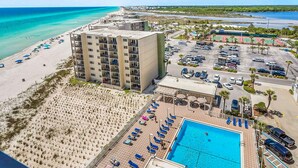 A hotel with a pool, beach, and parking lot. - Gorgeous beachfront condo, shared pool and beach access (Panama City Beach)
