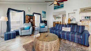 A living room with a sofa, armchairs, a coffee table, and a ceiling fan. - Sandpiper Cove Villa 20 (Destin)