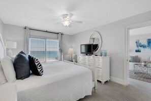 A bedroom with a bed, a television, a dresser, and a ceiling fan. - Amazing 5th Floor Condo Gulf Front, Pool, Beach Access, Near Shopping/Dining (Destin)