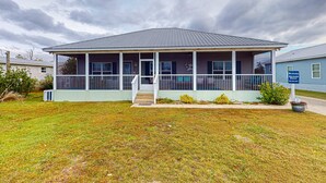 A single-story building with a covered porch and a small front yard.