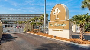 A hotel entrance with a sign reading "The Islander" and a view of the building in the background. - Colorful Gulf-view condo with pools, hot tub, tennis, gym & easy beach access (Destin)