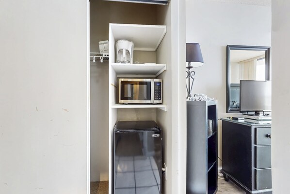 A compact kitchenette with a microwave, coffee maker, and refrigerator. - Cozy beachfront condo with shared pool and easy beach access (Miramar Beach)
