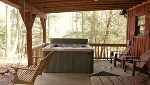 A wooden deck with a hot tub, wooden chairs, and a swing chair. - Creeksong-Harvest Moon (Logan)
