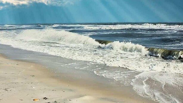 A beach with waves and a clear sky. - Spacious dog-friendly home with pool, hot tub, access to tennis, pickle ball, pools (St. George Island)