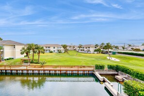 A residential area with a swimming pool, a well-maintained lawn, and multiple buildings. - Waterfront condo in private beach resort, best free amenities in Destin! (Destin)