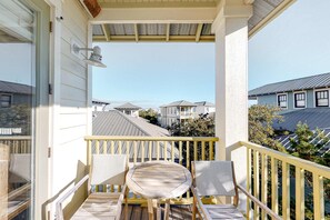 Outdoor dining - Modern coastal retreat with 2 balconies, grill, central AC, shared Pools, & WiFi (Santa Rosa Beach)