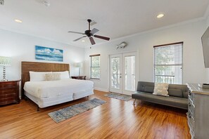 A bedroom with a bed, a sofa, a ceiling fan, and a window with blinds. - Three-Story Home w/Washer/Dryer, Gas Grill, Central A/C, & Shared Pool, Hot Tub (Destin)