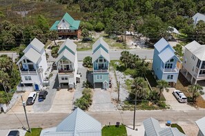 A residential area with multiple houses, each with a distinct architectural style and varying roof colors.