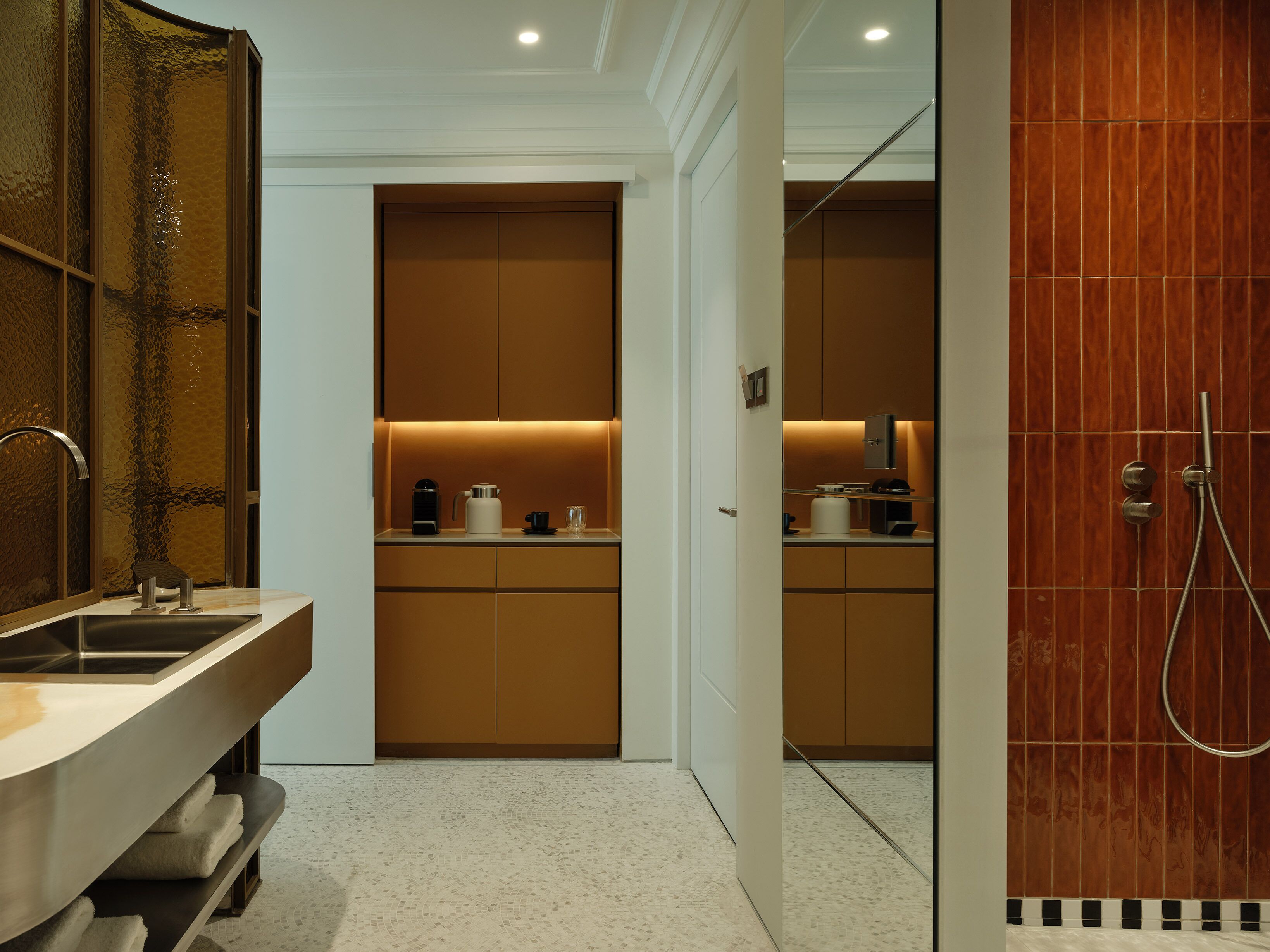 A modern bathroom with a sink, mirror, and shower.