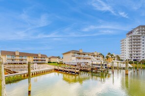 A waterfront hotel with multiple balconies, a dock, and a marina.