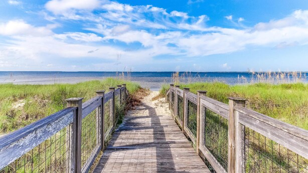A wooden boardwalk leading to a beach with a clear sky. - Dog friendly home and casita with pool plus beach access, central AC, and laundry (Port St. Joe)