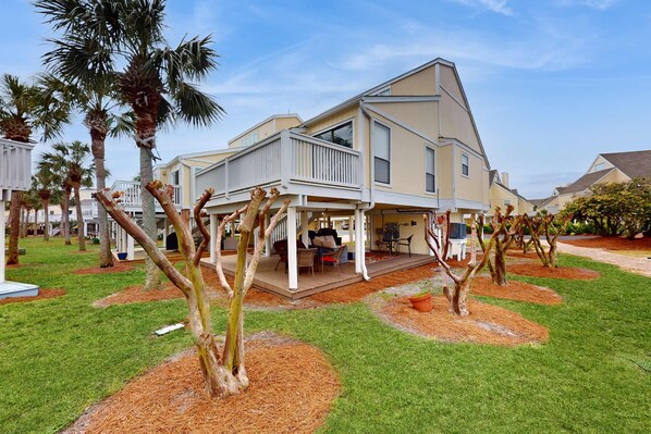 A two-story house with a covered porch and a patio. - Snowbird & dog-friendly condo with 5 pools, hot tubs, golf, tennis, pickleball (Destin)