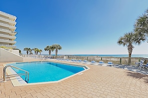A swimming pool with lounge chairs and palm trees, overlooking the ocean. - SeaSpray beachfront paradise with 3 pools, hot tub, marina, & tennis (Perdido Key)