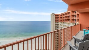 A balcony with a view of the beach and ocean. - Beachfront retreat with pool, hot tub, gym, & seasonal beach chairs & umbrella (Panama City Beach)