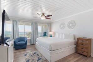 A bedroom with a bed, a chair, a dresser, and a ceiling fan. - Beachfront Townhouse w/ Modern Upgrades Shared Pool, Fast WiFi, Outdoor Shower (Panama City Beach)