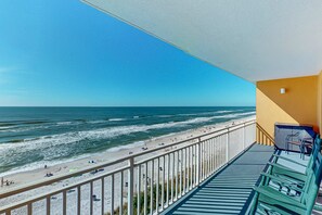 A balcony with a view of a beach and ocean. - Beachfront resort condo with Gulf views & pools/hot tub/lazy river/gym (Panama City Beach)