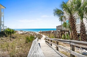 A wooden boardwalk leading to a beach with a clear view of the ocean. - Renovated Townhome with Central AC, Shared Pools & Hot Tubs–Minutes to Beach (Panama City Beach)